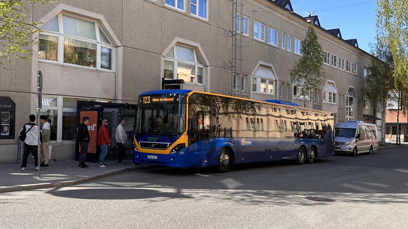 Bus stop with a bus and people